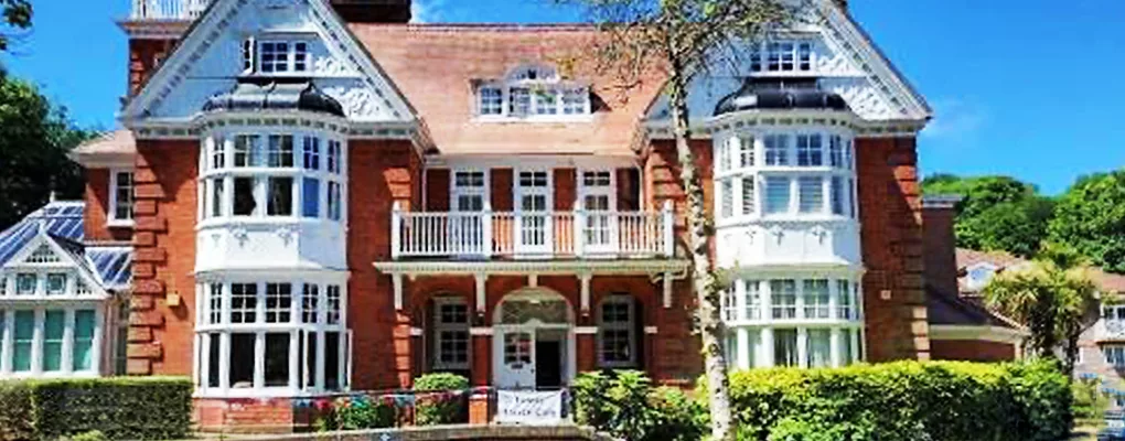 Tower House — red-brick building with white bay windows