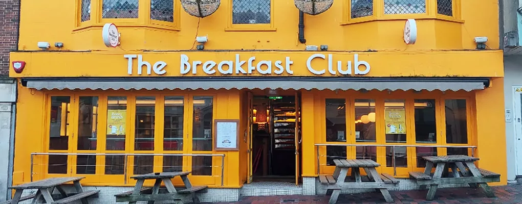 The Breakfast Club — yellow café frontage and outdoor seating